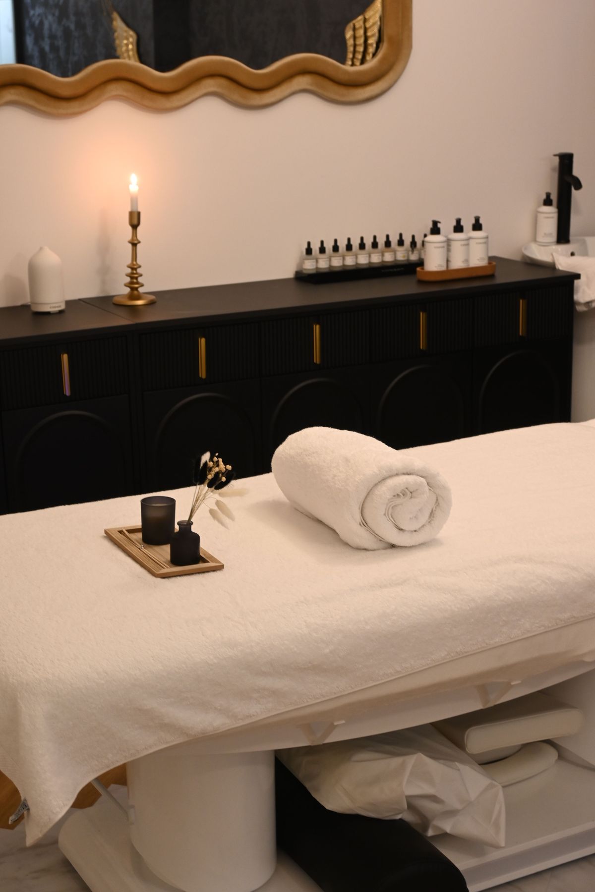 A prepared treatment room at Thai Healing Hands — pressed linens, candlelight, and curated oils