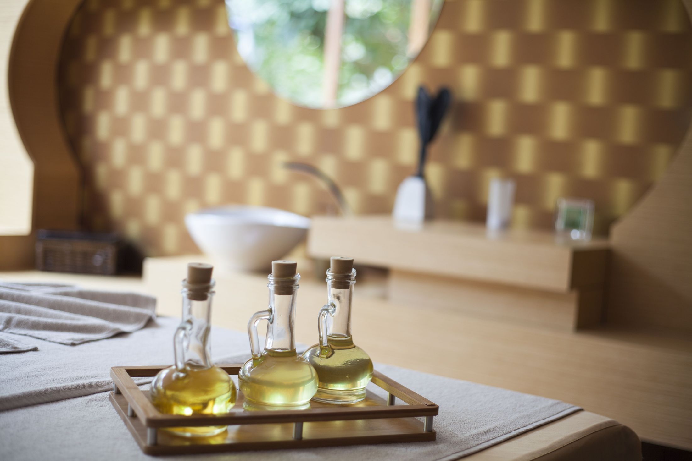 Golden massage oils prepared on a tray in the treatment room at Thai Healing Hands