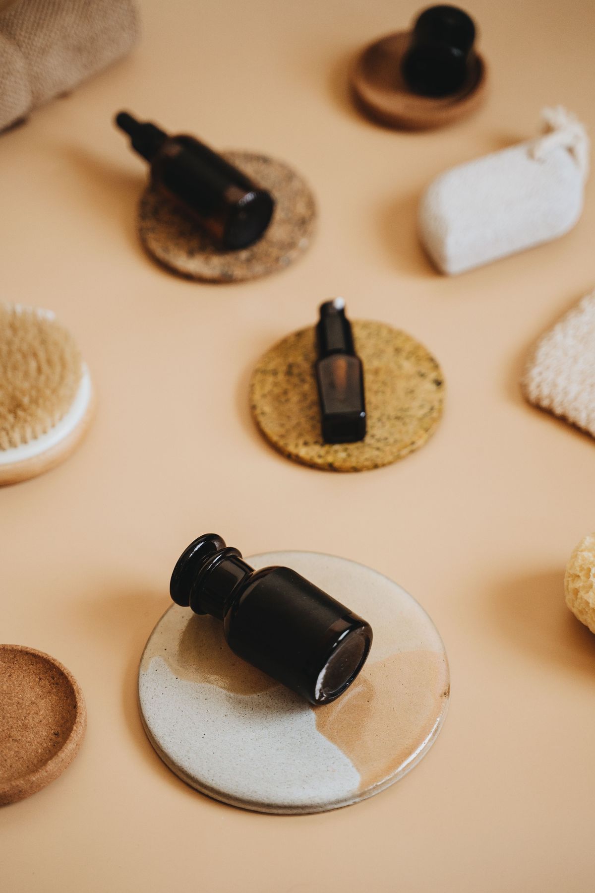 Amber essential oil bottles with natural spa accessories